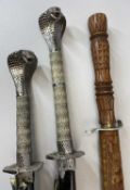 MODERN SAMURAI SWORDS (2) by Ancient Warriors with cobra design handles and lacquered scabbards,
