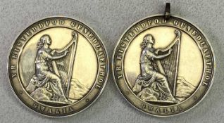 VICTORIAN EISTEDDFOD AWARD MEDALS (2) - designed by J Moore, the fronts depicting a woman playing