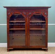 LATE VICTORIAN MAHOGANY STANDING BOOKCASE with ogee cornice, arched glazed doors with applied