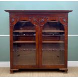 LATE VICTORIAN MAHOGANY STANDING BOOKCASE with ogee cornice, arched glazed doors with applied