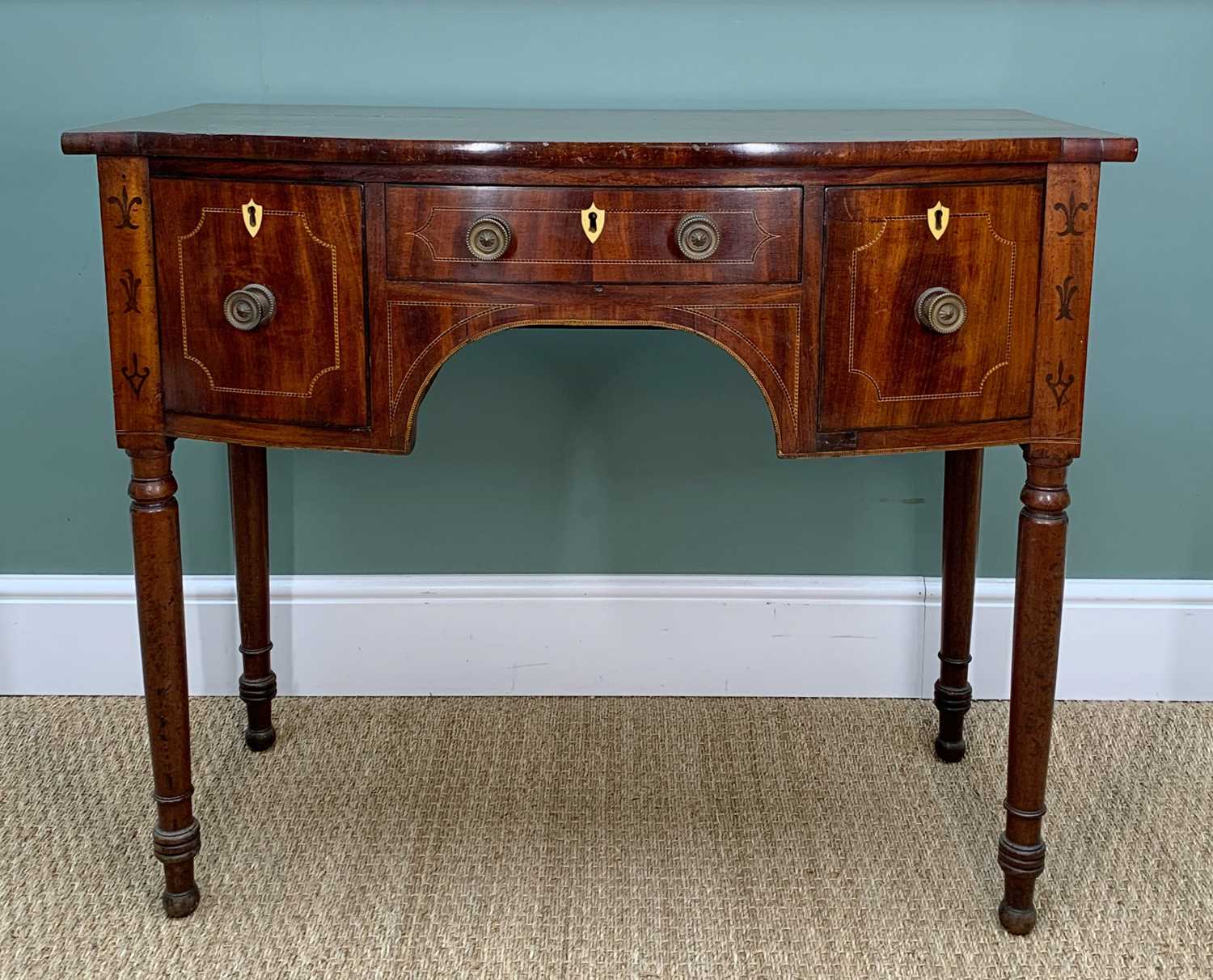 EARLY 19TH CENTURY MAHOGANY BOWFRONT SIDEBOARD, with chequer strung drawer fronts and under arch,