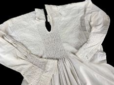 19TH CENTURY COTTON ROUND SMOCK, with floral needlework embroidered shoulders, cuffs and bodice,