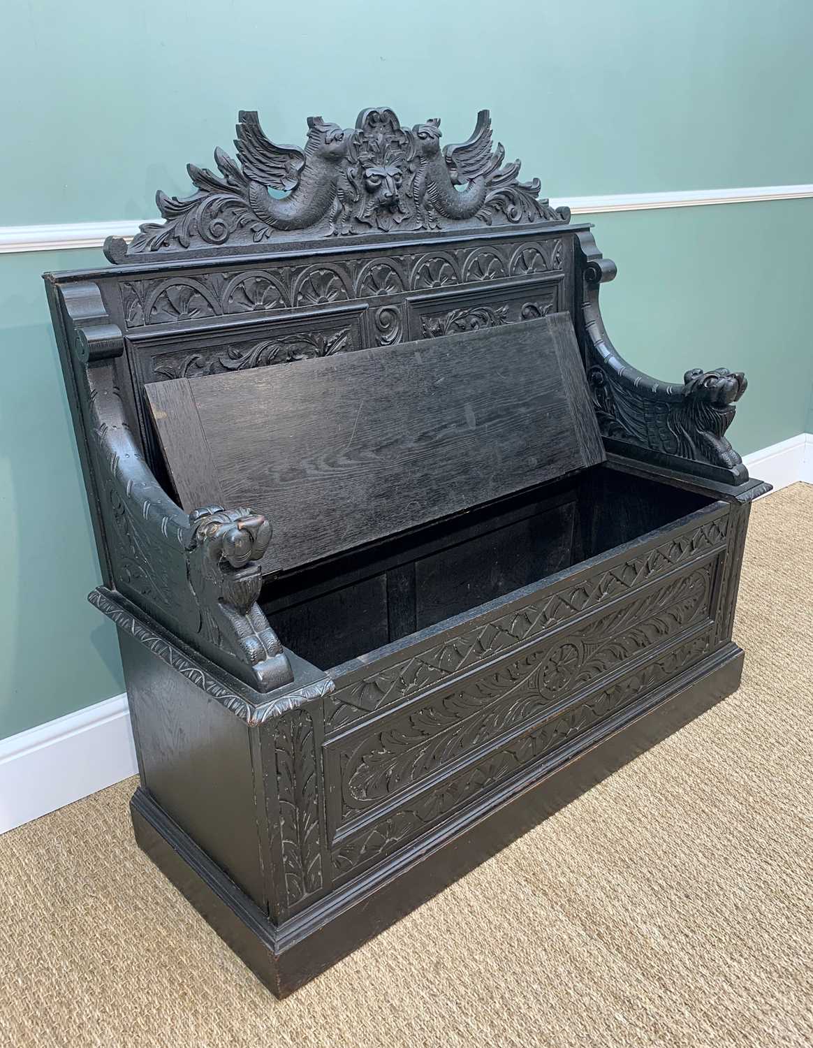 STAINED OAK BOX SETTLE, carved in the Renaissance revival style with Griffin and mask panelled back, - Image 4 of 13