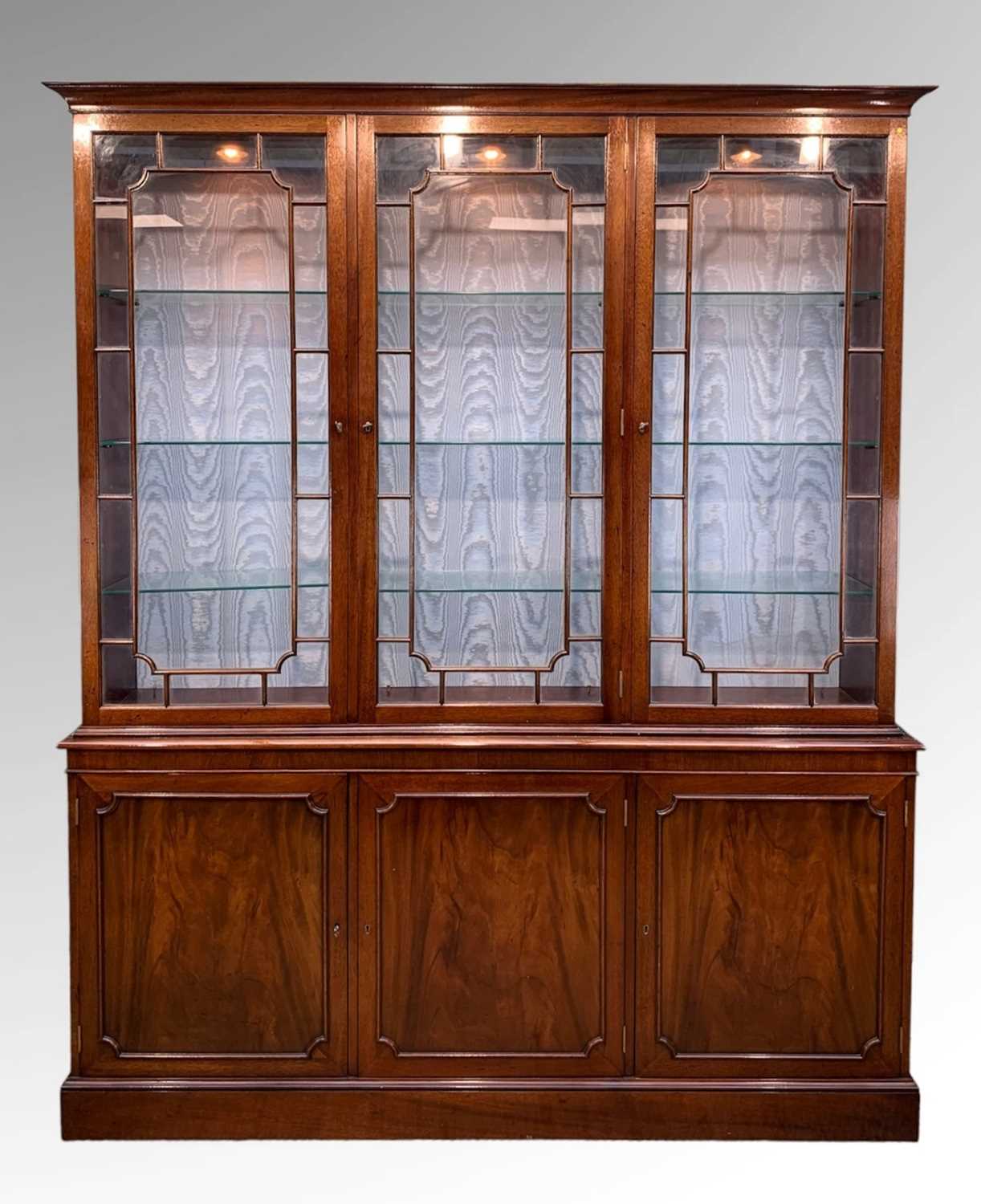 MODERN GEORGIAN STYLE MAHOGANY CABINET, with adjustable glass shelves, on a cupboard base, with a