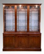 MODERN GEORGIAN STYLE MAHOGANY CABINET, with adjustable glass shelves, on a cupboard base, with a
