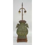 CHINESE SHANG-STYLE BRONZE URN TABLE LAMP, of Hu form, wood base and faded red shade