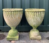 GARDEN ORNAMENTS: comprising pair composition stone shank fluted urns on socle bases, 66cm h (2)