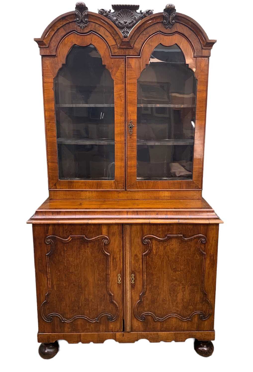 ANTIQUE DUTCH WALNUT CABINET, the upper portion with double domed cornice, glazed panel doors, on an