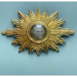 FRENCH GILTWOOD SUNBURST WALL TIMEPIECE, silvered engine turned 8.5cm dial with black enamelled