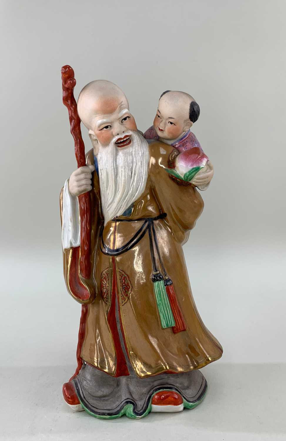 CHINESE FAMILLE ROSE PORCELAIN FIGURE OF SHOULAO, late Qing or Republic, standing with gnarled staff