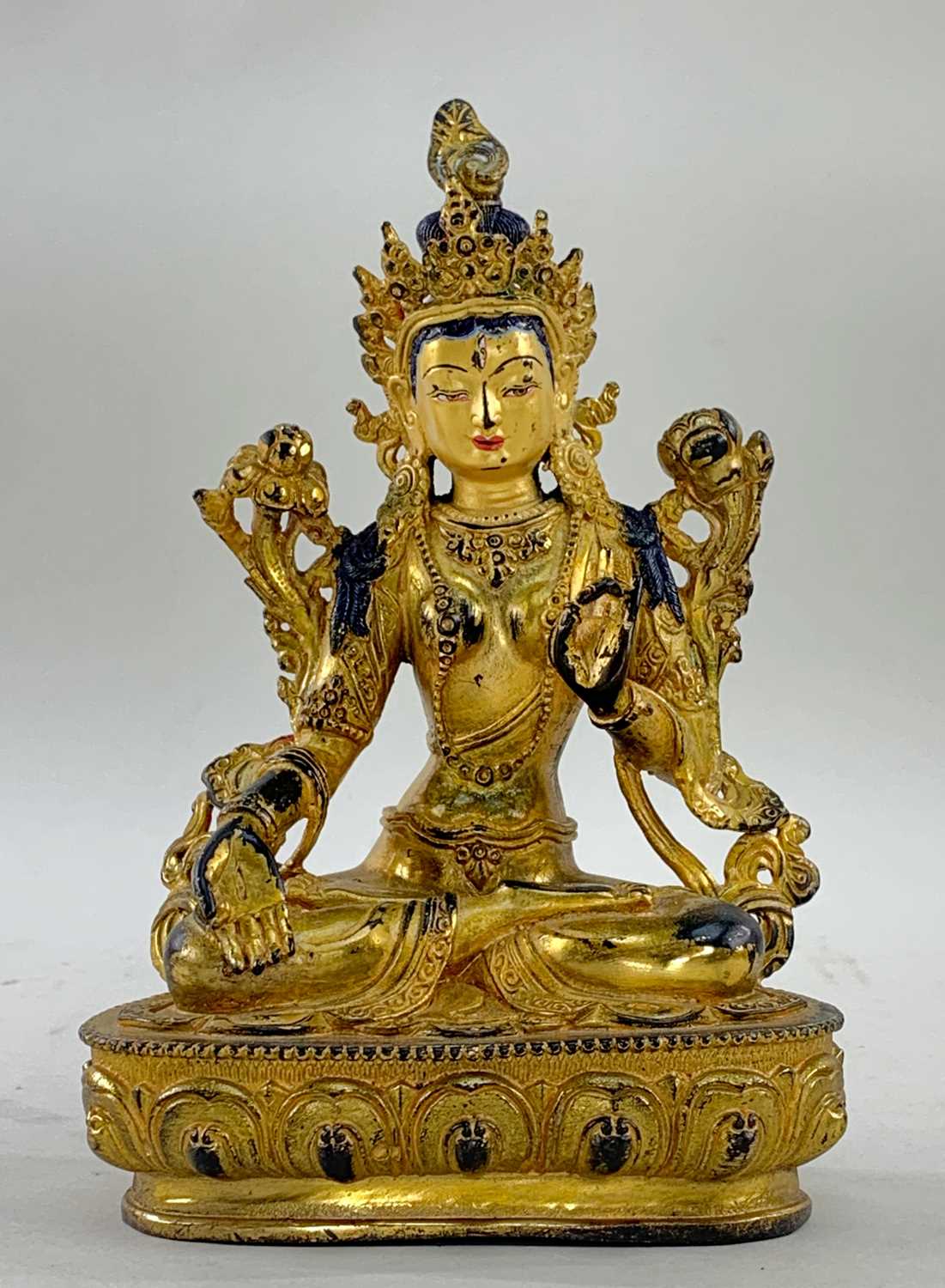 SINO-TIBETAN OR NEPALESE GILT BRONZE FIGURE OF GREEN TARA, seated in dhyanasana on lotus pedestal,