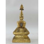 SINO-TIBETAN GILT COPPER STUPA, 19th Century, sealed square-section lotus engraved and double