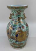 CANTON CELADON GROUND FAMILLE ROSE VASE, painted to one side with a scholar receiving a vase of