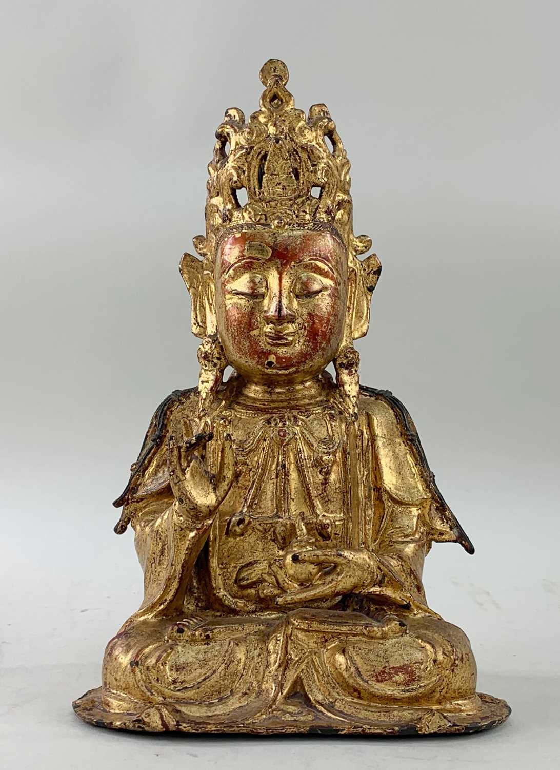 CHINESE LACQUERED GILT BRONZE FIGURE OF GUANYIN, Late Ming dynasty, the serene boddhisattva seated