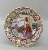 CHINESE FAMILLE ROSE PORCELAIN 'MANDARIN' SAUCER, Qianlong, lotus shaped rim, painted with a