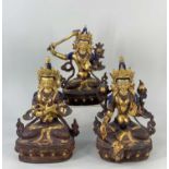 THREE MODERN NEPALESE FIGURES OF BODHISATTVAS, parcel gilt copper, including Green Tara seated, 21cm
