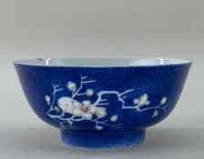 CHINESE COPPER RED & POWDER BLUE PORCELAIN BOWL, Kangxi, painted with two spays of flowering prunus,