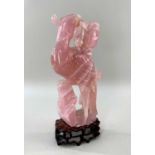 CHINESE ROSE QUARTZ CARVING OF A PHOENIX, with peony branch in its beak, wood stand Comments: