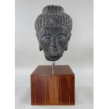 GANDHARA STYLE GREY STONE HEAD OF BUDDHA, carved with braided hair and topknot, downcast serene