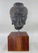 GANDHARA STYLE GREY STONE HEAD OF BUDDHA, carved with braided hair and topknot, downcast serene