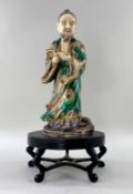 JAPANESE SATSUMA EARTHENWARE FIGURE OF A MONK, Meiji Period, wearing green and gilt mon robe with