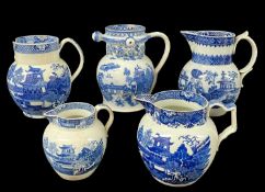 FIVE SWANSEA CAMBRIAN BLUE & WHITE TRANSFER PEARLWARE JUGS late 18th / early 19th Century, including