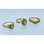 THREE 9CT PERIDOT RINGS, including a heart-cut peridot with diamond chip shoulders, tot gross wt.