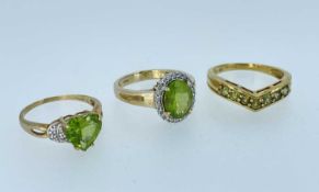 THREE 9CT PERIDOT RINGS, including a heart-cut peridot with diamond chip shoulders, tot gross wt.