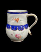 CHELSEA-DERBY MUG, c.1775, the bell-shaped body with ribbed neck, painted with flower sprays beneath