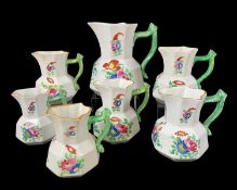 SEVEN DILLWYN SWANSEA POTTERY MATCHING TWIG-HANDLED JUGS circa 1820, including four graduated,