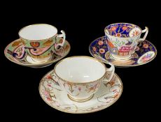 THREE SWANSEA PORCELAIN CUPS & SAUCERS comprising example with formal arrangement of gilded and iron