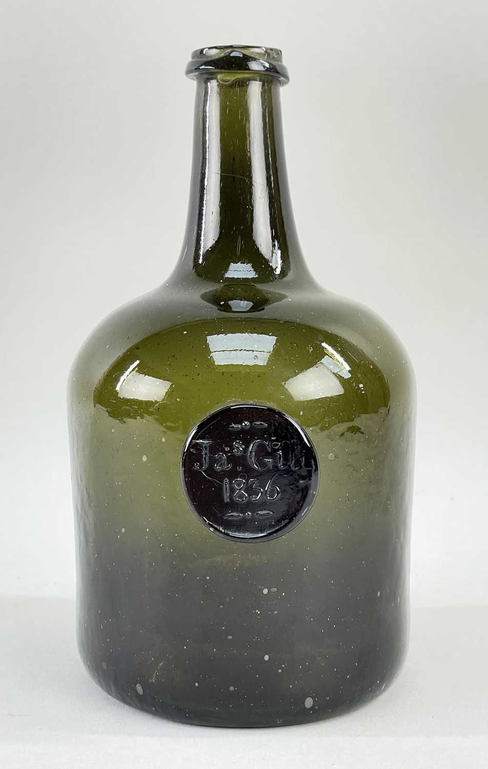 WINE BOTTLE, mallet shape, dark olive-green glass, later applied to the shoulder with a circular