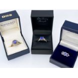 THREE 9CT TANZANITE RINGS, comprising 3-stone, single oval stone and cushion cut square stone rings,