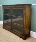 MODERN REPRODUCTION OAK BOOKCASE, with carved frieze, glazed doors, on bracket feet, 120 w x 27 d