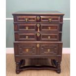 17TH CENTURY OAK GEOMETRIC FRONTED TWO PART CHEST ON STAND, fitted three graduated long drawers on a