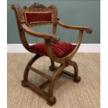 EARLY 20TH CENTURY SAVONAROLA CARVED WALNUT ARMCHAIR, with red velvet padded back, loose cushion and