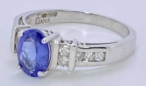 18CT WHITE GOLD & POSSIBLY BLUE TANZANITE & DIAMOND RING - approx 1ct oval facet cut central