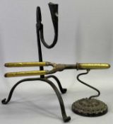 A STEEL RUSH LIGHT HOLDER - 19th century with candleholder to side and on tripod base with scroll