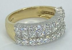 18CT GOLD & PLATINUM TRIPLE ROW DIAMOND RING - having 10 in line channel set Princess cut diamonds