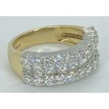 18CT GOLD & PLATINUM TRIPLE ROW DIAMOND RING - having 10 in line channel set Princess cut diamonds