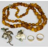 9CT GOLD RINGS (2), amber necklaces (2), 900 silver stamped brooches (2), the rings include a lady's