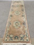 CHINESE WASHED WOOLEN RUG/CARPET RUNNER - with label for G H Frith Ltd, peach colour, 320 x 76cms