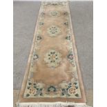 CHINESE WASHED WOOLEN RUG/CARPET RUNNER - with label for G H Frith Ltd, peach colour, 320 x 76cms