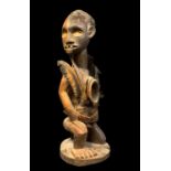 KONGO KNEELING FETISH FIGURE, with feather and fetish bundles, 38cm h