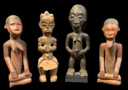 FOUR AFRICAN FIGURES, including seated Bembe pair 28cm h, Tabwa male 33cm h, and Fang figure 31cm