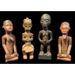 FOUR AFRICAN FIGURES, including seated Bembe pair 28cm h, Tabwa male 33cm h, and Fang figure 31cm