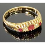 18CT CHESTER GOLD LADY'S DRESS RING having two small diamonds and three ruby colour stones to an