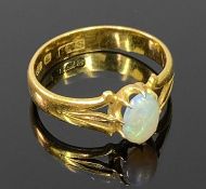 VICTORIAN 22CT GOLD OPAL RING - 7 x 5mm cabochon opal in an open back claw mount against openwork