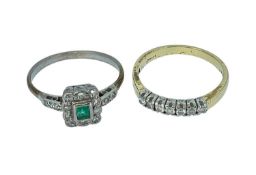TWO DIAMOND RINGS comprising 18K gold seven stone diamond ring and an emerald and diamond cluster