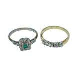 TWO DIAMOND RINGS comprising 18K gold seven stone diamond ring and an emerald and diamond cluster